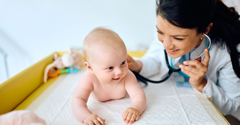 Pediatric doctor examining child for hernia